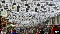 Posters of the election candidates hang over a street ahead of the 2024 general elections, in Dhaka, Bangladesh.