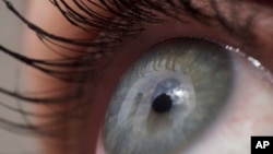 This April 12, 2018 photo shows a very close up image of a woman's eye. (AP Photo/Patrick Sison)