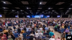 Messengers stand for worship during a Southern Baptist Convention annual meeting, June 11, 2024, in Indianapolis. 