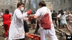 Rescuers, medical staff and volunteers clean up the rubble and search victims after Russian missile strikes on Okhmatdyt Children's Hospital in Kyiv, Ukraine, July 8, 2024.