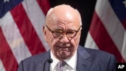 FILE - Rupert Murdoch introduces Secretary of State Mike Pompeo during the Herman Kahn Award Gala, Oct. 30, 2019, in New York. In a deposition, Rupert Murdoch appeared to acknowledge that several on-air personalities had gone beyond reporting on allegations about Dominion and had "endorsed" them.