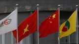 FILE - Vietnamese flag (2nd L) and Chinese flag (2nd R) are seen at a Chinese plastic company in Bac Giang, Vietnam August 12, 2017. (REUTERS/Kham)