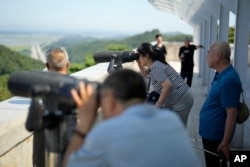 Visitors use binoculars to see the North Korean side from the unification observatory in Paju South Korea, on Sept. 7, 2023, ahead of North Korea's 75th founding anniversary, which is on Sept. 9.