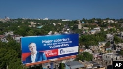 FILE - A political billboard with a message that reads in Spanish: 'Better health coverage for the most vulnerable sectors', promotes the candidacy of incumbent President Luis Abinader, in Santo Domingo, May 16, 2024.