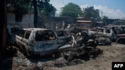 The charred remains of vehicles that were burned near a garage are seen in Port-au-Prince, Haiti, on March 25, 2024.