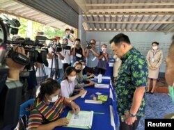 FILE - Thailand's Health Minister and cannabis advocate Anutin Charnvirakul, wearing a shirt with marijuana leaves, casts his ballot at a polling station in Buriram, Thailand, May 14, 2023. Bhumjaithai, a party that has made legalized cannabis its defining issue, finished third with 71. (Bhumjaithai Party/Handout via Reuters)