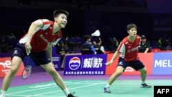 Feng Yanzhe (L) of China hits a return beside partner Huang Dongping during their mixed doubles match against Hana Tarek Zaher and Ahmed Salah of Egypt at the Sudirman Cup Finals 2023 world badminton championships in Suzhou, China, May 14, 2023.