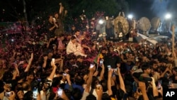 巴基斯坦民众在拉合尔向前总理伊姆兰·汗乘坐的汽车抛洒玫瑰花瓣，欢迎汗回家。（2023年513日）