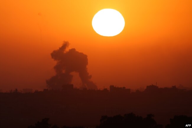 This picture taken from Israel's southern border with the Gaza Strip shows smoke billowing in the Palestinian territory at sunset following Israeli bombardment on June 2, 2024.