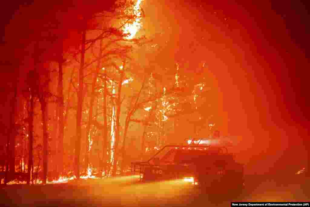 A massive wildfire tears through 3,800 acres in the state&#39;s pine barrens in Ocean County, New Jersey, as firefighters battle the blaze&nbsp;with 200-foot high flames. No one was injured and property was intact, officials.