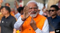 Indian Prime Minister Narendra Modi, shows the indelible ink mark on his index finger after casting his vote during the third phase of general elections, in Ahmedabad, Gujarat, India, May 7, 2024. 