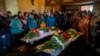 Relatives and family friends attend the funeral of Sofia Shulha, 11, and Kyrylo Pysarev, 17, in Uman, central Ukraine, April 30, 2023. Both were killed during a Russian attack on a residential building early Friday morning.