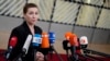 Denmark's Prime Minister Mette Frederiksen speaks with the media as she arrives for an EU summit at the European Council building in Brussels, Dec. 14, 2023. 