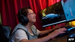 María Elena Arévalo, 81, plays Free Fire, a popular online video game, at home at her home in Llay-Llay, Valparaiso Region, Chile, on Dec. 19, 2023. (Photo by Pablo Vera / AFP)