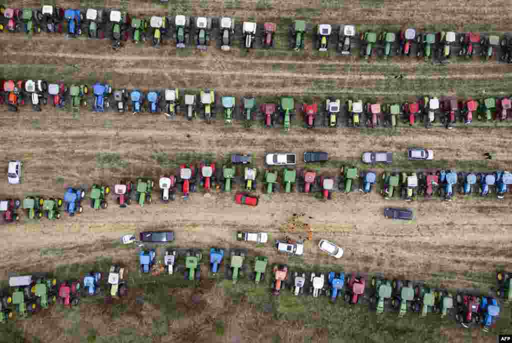 This aerial picture shows tractors parked in a field during a protest against the lifting of ban on imports of grain coming from Ukraine, in Dolni Bogrov, near Sofia, Bulgaria. (Photo by Nikolay DOYCHINOV / AFP)