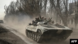Ukrainian service members head toward Bakhmut in a BMP infantry fighting vehicle, in eastern Ukraine on March 22, 2023.