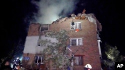 Firefighters put out a blaze at an apartment building damaged in ta e Russian missile attack in Kharkiv, Ukraine, May, 31, 2024.