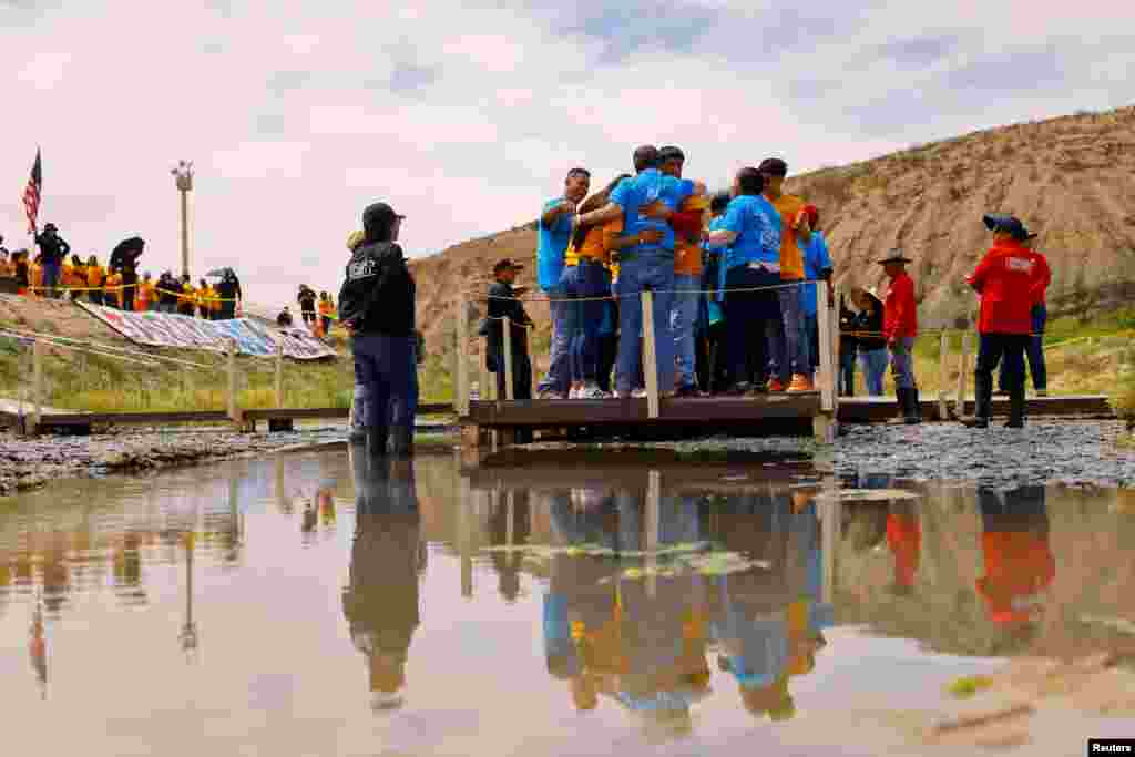 Families hug each other in a reunification meeting for relatives separated by deportation and immigration, in the Rio Bravo river borderline between Ciudad Juarez, Mexico and El Paso, U.S., in Ciudad Juarez, Mexico, May 6, 2023.