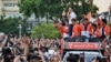 Move Forward Party leader and prime ministerial candidate Pita Limjaroenrat leads a victory parade with fellow party members and supporters outside Bangkok City Hall on May 15, 2023.