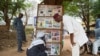 FILE - Men look at headlines from various newspapers in Bamako on June 11, 2021. Mali’s junta issued an order April 11, 2024, prohibiting all forms of media from reporting on activities of political groups.