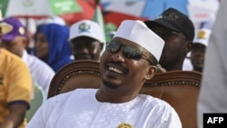 FILE — Chad's transitional president and presidential election candidate Mahamat Idriss Deby Itno (C) reacts as he sits in the Place des Nations during final presidential election campaign rally, in N'Djamena on May 4, 2024. 