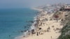 Palestinians enjoy the beach on a hot day amid the ongoing conflict between Israel and Hamas in Deir Al-Balah, in the central Gaza on April 17, 2024. (Ramadan Abed/Reuters)