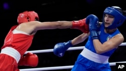 Algeria's Imane Khelif, left, fights Angela Carini of Italy in their women's 66-kilogram preliminary boxing match at the 2024 Summer Olympics on Aug. 1, 2024, in Paris, France. Khelif won after Carini abandoned the fight after 46 seconds.