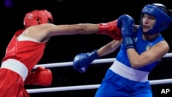 Algeria's Imane Khelif, left, fights Italy's Angela Carini in their women's 66-kilogram preliminary boxing match at the 2024 Summer Olympics on Aug. 1, 2024, in Paris, France.