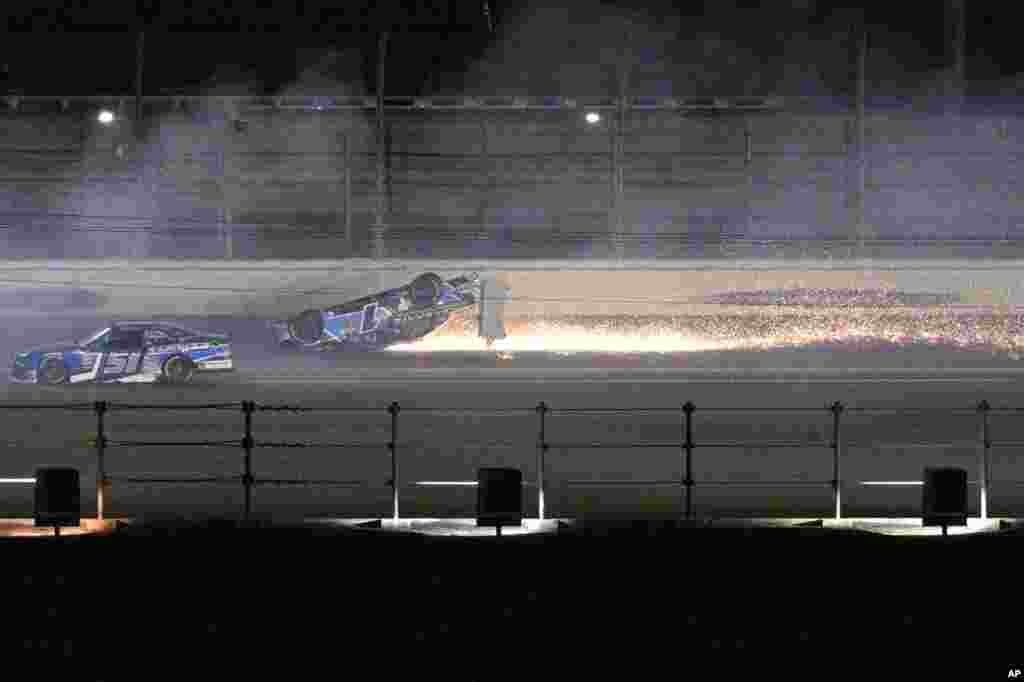 Sam Mayer&#39;s car slides on its roof along the back stretch after a collision on the final lap of the NASCAR Xfinity Series auto race at Daytona International Speedway, Feb. 18, 2023, in Daytona Beach, Florida.