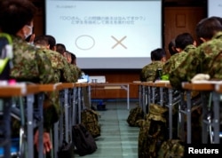 Japan Ground Self-Defence Force (JGSDF) soldiers participate in a seminar to prevent harassment at JGSDF Camp Asaka, in Tokyo, Japan April 16, 2024. (REUTERS/Sakura Murakami)