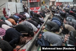 Warga Palestina melaksanakan salat Idulfitri di tengah guyuran hujan, saat konflik Israel dan Hamas, di bagian utara Jalur Gaza, 10 April 2024. (Foto: REUTERS/Mahmoud Issa)