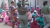 A freed female prisoner hugs a prison officer after being released from Chikurubi maximum prison on the outskirts of Harare, Zimbabwe, May, 19, 2023. 