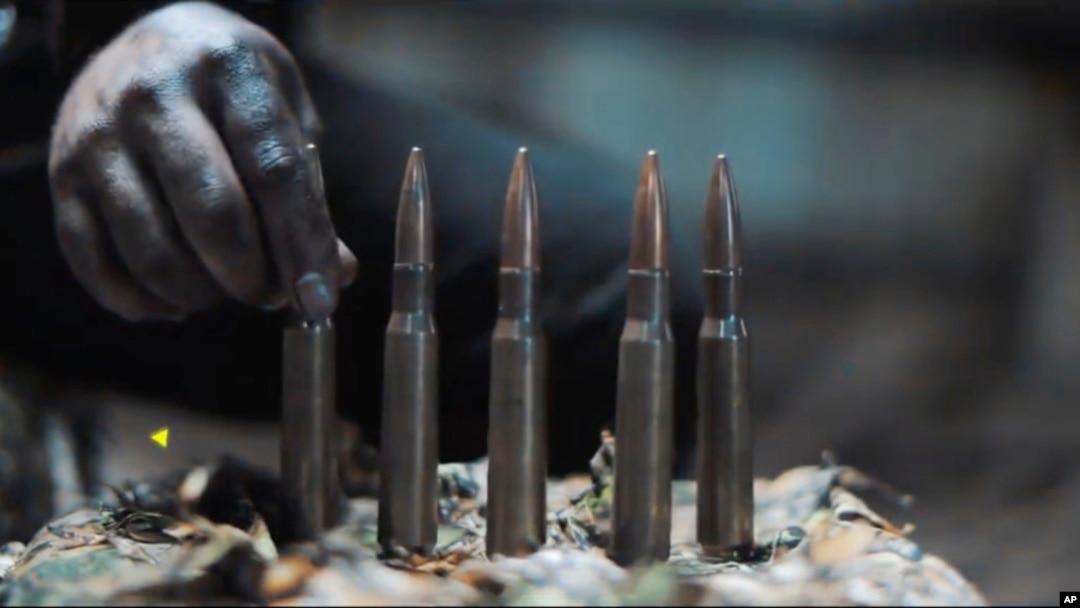In this image from a propaganda video released by Hamas in October 2023, a fighter lines up cartridges for a large sniper rifle. Weapons experts told The Associated Press the gun is an Iranian-made AM-50 Sayyad.