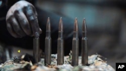 In this image from a propaganda video released by Hamas in October 2023, a fighter lines up cartridges for a large sniper rifle. Weapons experts told The Associated Press the gun is an Iranian-made AM-50 Sayyad.
