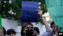 A social group, Aurat March, hold signs during a demonstration against Pakistani government, in Karachi, Oct. 29, 2023. Pakistan has recently announced plans to deport all migrants who are in the country illegally, including 1.7 million Afghans.