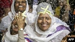 Ethiopian Christian worshipers are sprinkled with holy water during the Palm Sunday service at the Coptic Orthodox Monastery of Simon the Tanner,&nbsp;also known as the Cave Church,&nbsp;in the eastern hillside Mokkatam district of Cairo, Egypt.