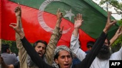 Pakistan Tehreek-e-Insaf (PTI) party activists and supporters of Pakistan's former Prime Minister Imran Khan celebrate after Supreme Court declared Khan's arrest "invalid", in Lahore, Pakistan, May 11, 2023.