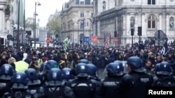 FILE - French gendarmes stand in position during a demonstration in front of the Paris City Hall after French government's pension reform received the Constitutional Council's approval on April 14, 2023.