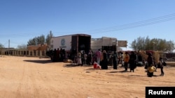 FILE: Sudanese prepare to ride on trucks to Egypt through the Qustul border crossing, in the Sudanese city of Wadi Halfa, Sudan May 1, 2023. Sudanese and other nationalities resort to spending the nights on metal beds in Wadi Halfa waiting for their Egyptian visas.