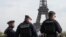 Police officers patrol the Trocadero plaza near the Eiffel Tower in Paris, Oct. 17, 2023. 