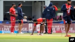 Aaron Jones of the US inspects the field before an ICC Men's T20 World Cup cricket match between the US and Ireland at the Central Broward Regional Park Stadium in Lauderhill, Fla., June 14, 2024.