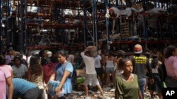 People take items from stores in the aftermath of Hurricane Otis in Acapulco, Mexico, Oct. 28, 2023.