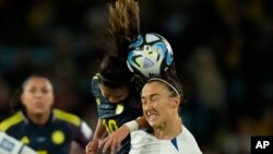 Colombia's Leicy Santos and England's Lucy Bronze jump for the ball during a Women's World Cup quarterfinal soccer match in Sydney on Aug. 12, 2023.