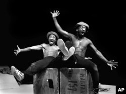 FILE — Percy Mtwa, left, and Mbongeni Ngema perform a scene from "Woza Albert," at the Market Theatre in Johannesburg, South Africa, in 1981.