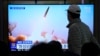 A TV news program on March 10, 2023, shows an image of a North Korean missile launch, at the Seoul Railway Station in South Korea. North Korean leader Kim Jong Un supervised an artillery drill simulating an attack on the South, state media said Friday.
