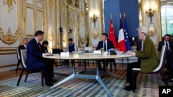 French President Emmanuel Macron, center, China’s President Xi Jinping and European Commission President Ursula von der Leyen attend a trilateral meeting at the Elysee Palace as part of Xi’s two-day state visit to France, in Paris, May 6, 2024.