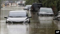 Vehicles are submerged in floodwaters caused by the tropical storm named Khanun in Changwon, South Korea, Aug. 10, 2023. 