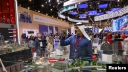 A visitor takes pictures of an exhibition stand at the St. Petersburg International Economic Forum (SPIEF) in Saint Petersburg, Russia, June 5, 2024. 