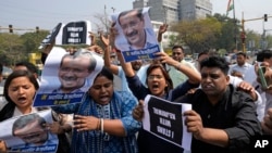 Supporters of Aam Admi Party, or Common Man's Party, shout slogans during a protest against the arrest of their party leader Arvind Kejriwal, in New Delhi, March 22, 2024.