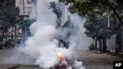 A protester runs away from tear gas fired by police in Nairobi, Kenya, July 16, 2024. 